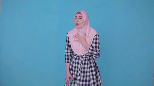 a Young Muslim Woman Having an Asthma Attack,uses Spray alt