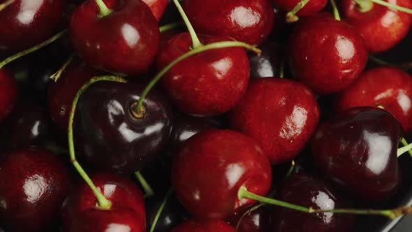 Tracking shot over bowl of cherries. alt