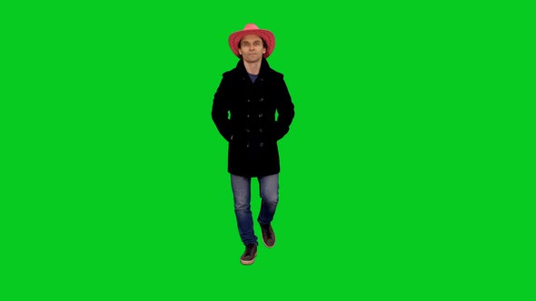 Stylish Man in Pink Cowboy Hat Moving with Hands in Pockets on Green Screen