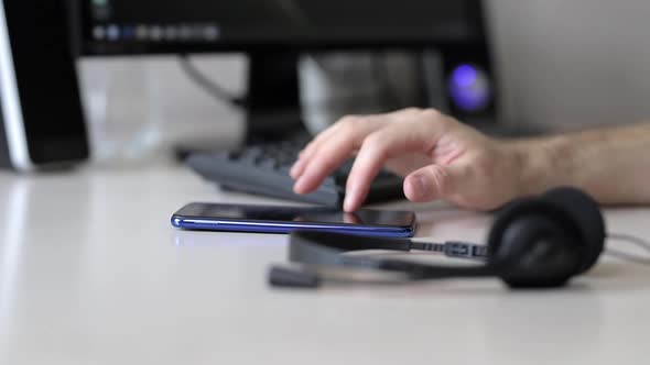 Office worker browses social networks on the phone alt
