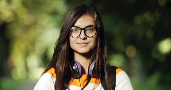 Portrait of Smiling Woman Student in Park