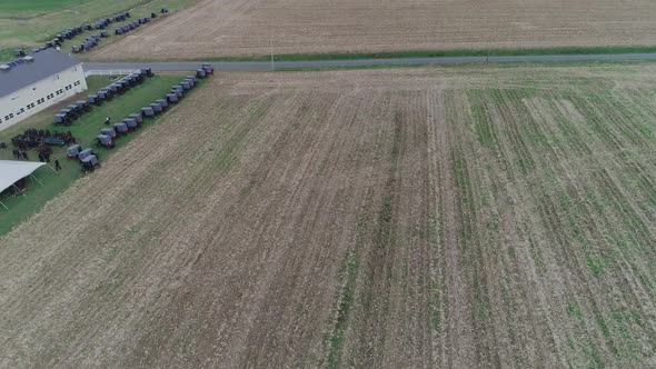 Ariel View of an Amish Wedding on an Autumn Day with Buggies, an Amish Playing Volley Ball as seen b alt