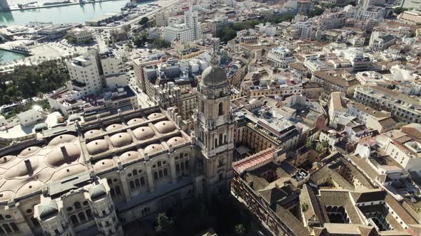 Topdown view Malaga Cathedral tower bell surrounded by downtown buildings, Spain