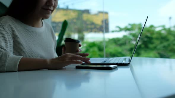 A woman touching and scrolling on smart phone screen