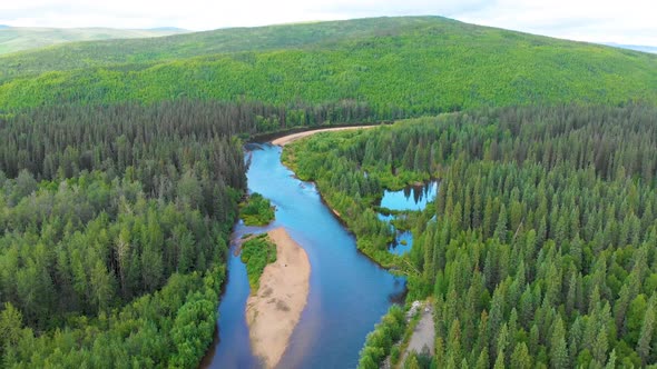 4K Drone Video (high elevation) of Beautiful Chena River as it runs through Pine Tree Covered Mounta alt