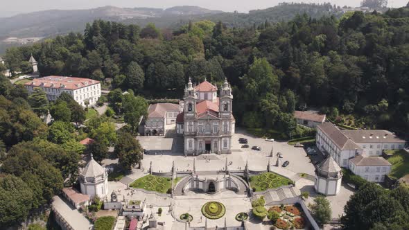 Top down rotation over Famous Bom Jesus Church on top of hill surrounded by Nature alt