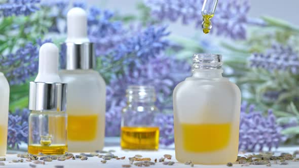 Super Slow Motion Shot of Oily Lavender Essence Drop Into Phial at 1000Fps alt