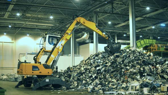 Mechanical Loader Is Transporting Rubbish Indoors. Garbage, Trash, Waste Recycling Factory alt