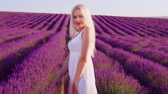 Portrait of a Blonde Woman with Hat in Lavender Fields on Summer