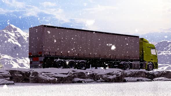 Moving Freight Truck on Snowy Mountainous Rocky Road