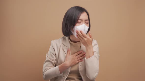 Asian business woman was sick with fever wearing hygienic mask standing isolated