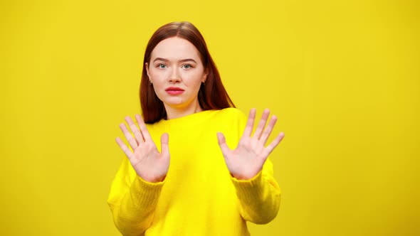 Scared Young Caucasian Redhead Woman Stretching Hands Moving Away From Camera in Slow Motion alt