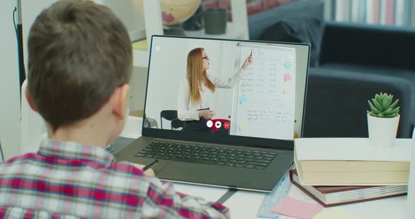 Child Little School Boy Kid Schoolboy Children Using Tablet Laptop Computer for Homework at Home alt
