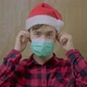 Guy in Santa Hat Takes Off His Medical Mask - VideoHive Item for Sale
