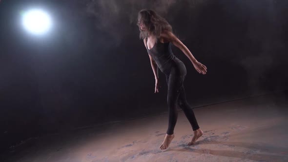 Young Dancer Woman Is Dancing in Dusty Dark Room, Energy and Active Dance alt