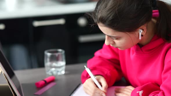 Beautiful Caucasian Female Student is Studying in College Remotely alt