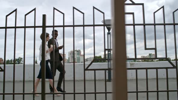 Office Workers Eating Fast Food and Drinking Coffee during Walk Outdoors alt