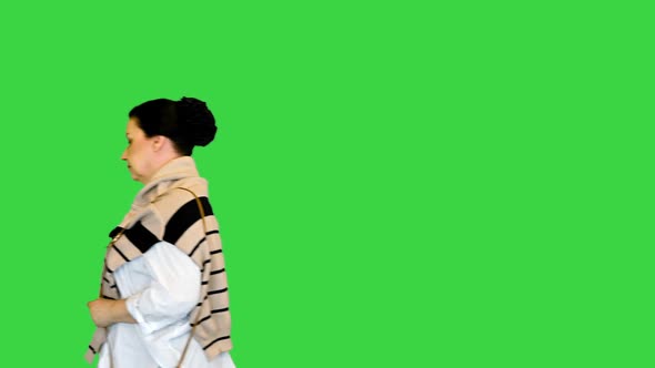 Mature Woman in White Shirt Walking By on a Green Screen Chroma Key alt
