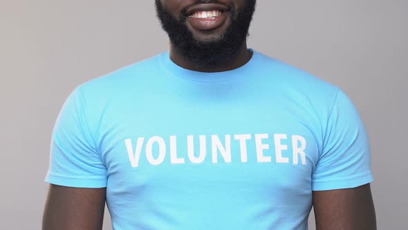 Smiling African American Volunteer Holding Cardboard Giftbox, Assistance Charity alt