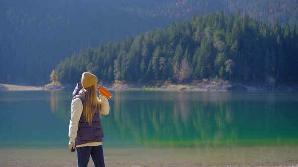 A Young Woman Visits the Crno Jezero or the Black Lake Near the City of Zabljak alt