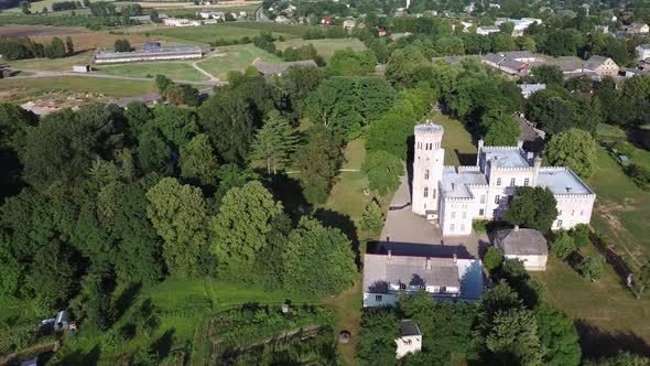 Vecauce Manor in Latvia Aerial View of the Pink Castle Through the Park. Vecauce Castle Tower With a alt