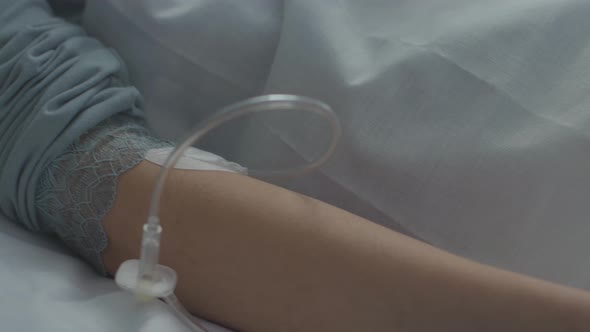 Injured woman lying in a hospital bed with cervical collar and IV