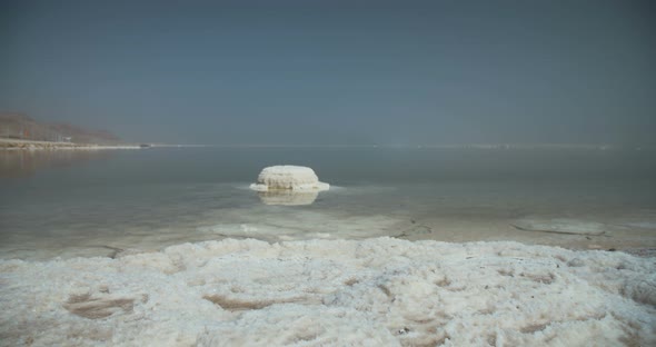 Tracking shot of salt deposits on the banks of the Dead Sea in israel alt