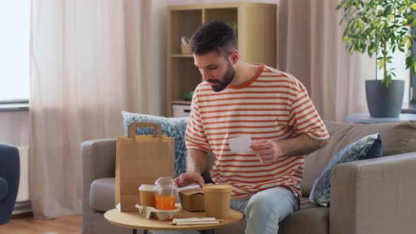 Man with Bill Checking Takeaway Food Order at Home