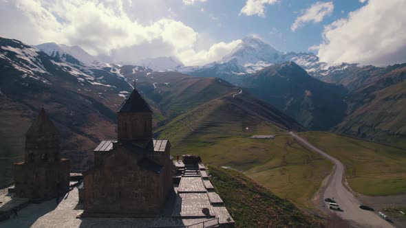 Birdseye View of Gergety Trinity Church and Caucasus Mountains Georgia alt