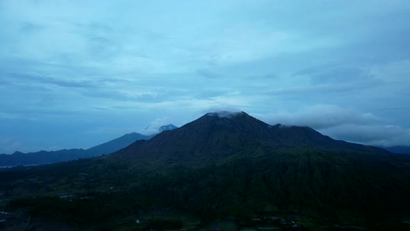 Agung mount at sunset 4K time lapse day to night clouds running over mountain volcano Bali Indonesia