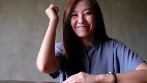 A young asian woman playing Rock Paper Scissor game