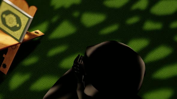 Muslim Woman Praying After Reading Quran in Mosque alt