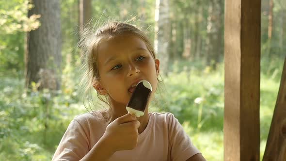 Kid Licking Ice-Cream. Charming Child Eats Ice Cream Outside