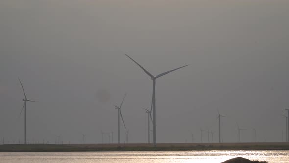 Wind turbines on the seashore in the evening