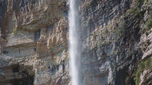 High waterfall next to a cliff alt