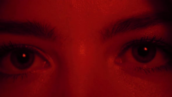 Macro of Woman's Blue Eye in Red Light with Flash