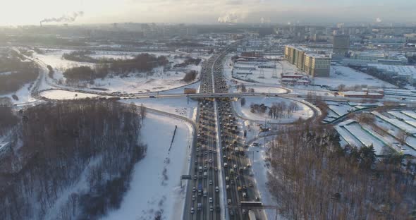 Cars on Highway at Sunny Winter Morning in the City. Aerial View alt