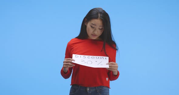 Young Woman Holding Discount Sign alt