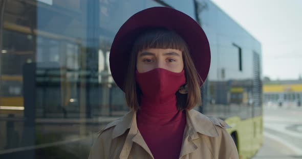 Portrait of Millennial Girl in Protective Cotton Mask Turning Head and Looking To camera alt