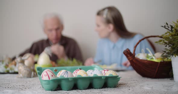 Happy Easter - Senior Man Eating Easter Holiday Breakfast with Granddaughter. alt