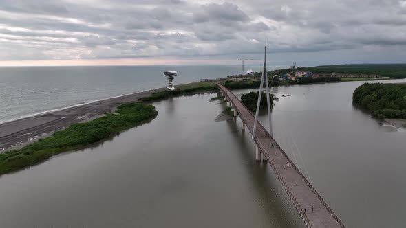 Anaklia, Georgia - July 16 2022: Aerial view of Anaklia-Ganmuhkuri Pedestrian Bridge at sunset alt