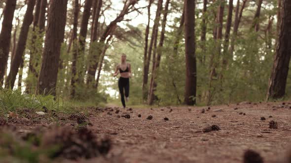 Young Woman Jogging in the Forest