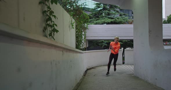 ACTIVE Womana Running in Downtown at Night in Urban Environment alt