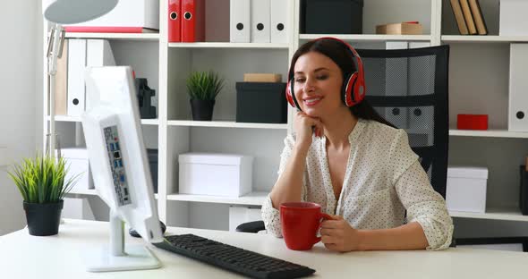 Businesswoman in White Blouse Listening Music and Looking To Monitor