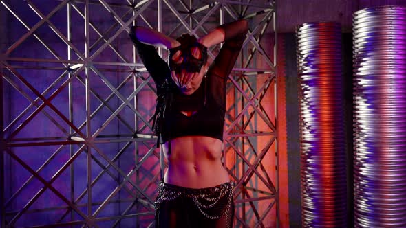 Closeup of a Woman Dancing a Modern Dance in an Unusual Studio She is Dressed in a Revealing Suit alt