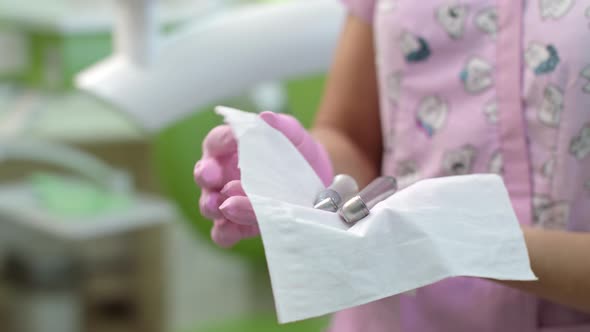 Dentist Disinfecting Dentistry Tools. Doctor Hands Preparing Dental Equipment alt