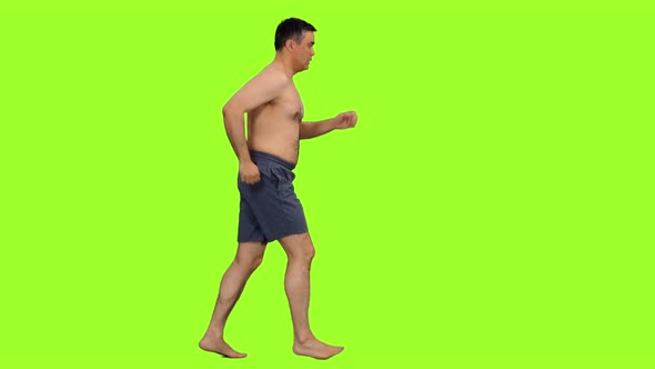 Shirtless Adult Man Jogging in Gray Shorts