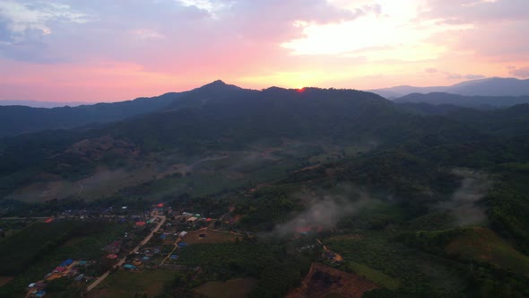 Aerial view from a drone over a misty landscape on the farmland alt