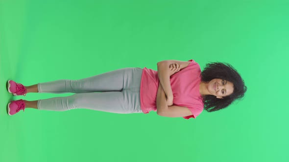 Portrait of Young Female African American Coquettishly Smiling Waving Hand and Showing Gesture Come alt