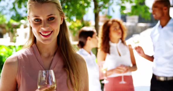 Beautiful woman holding a glass of wine at restaurant alt